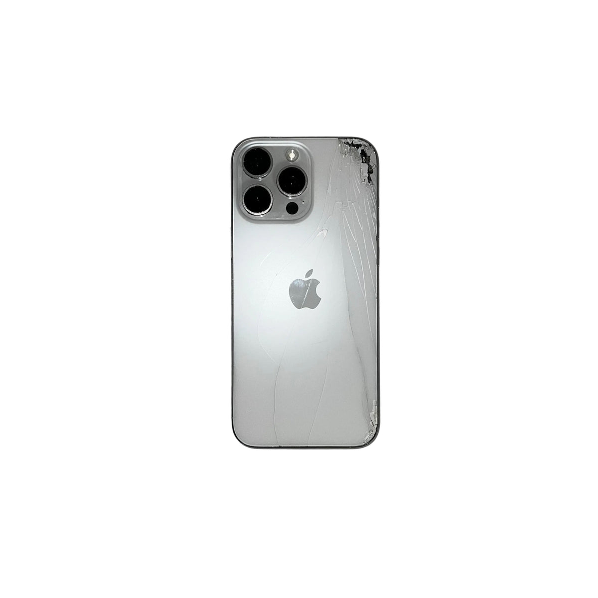 A silver Apple iPhone with a heavily cracked glass back panel, photographed from above on a gray surface.